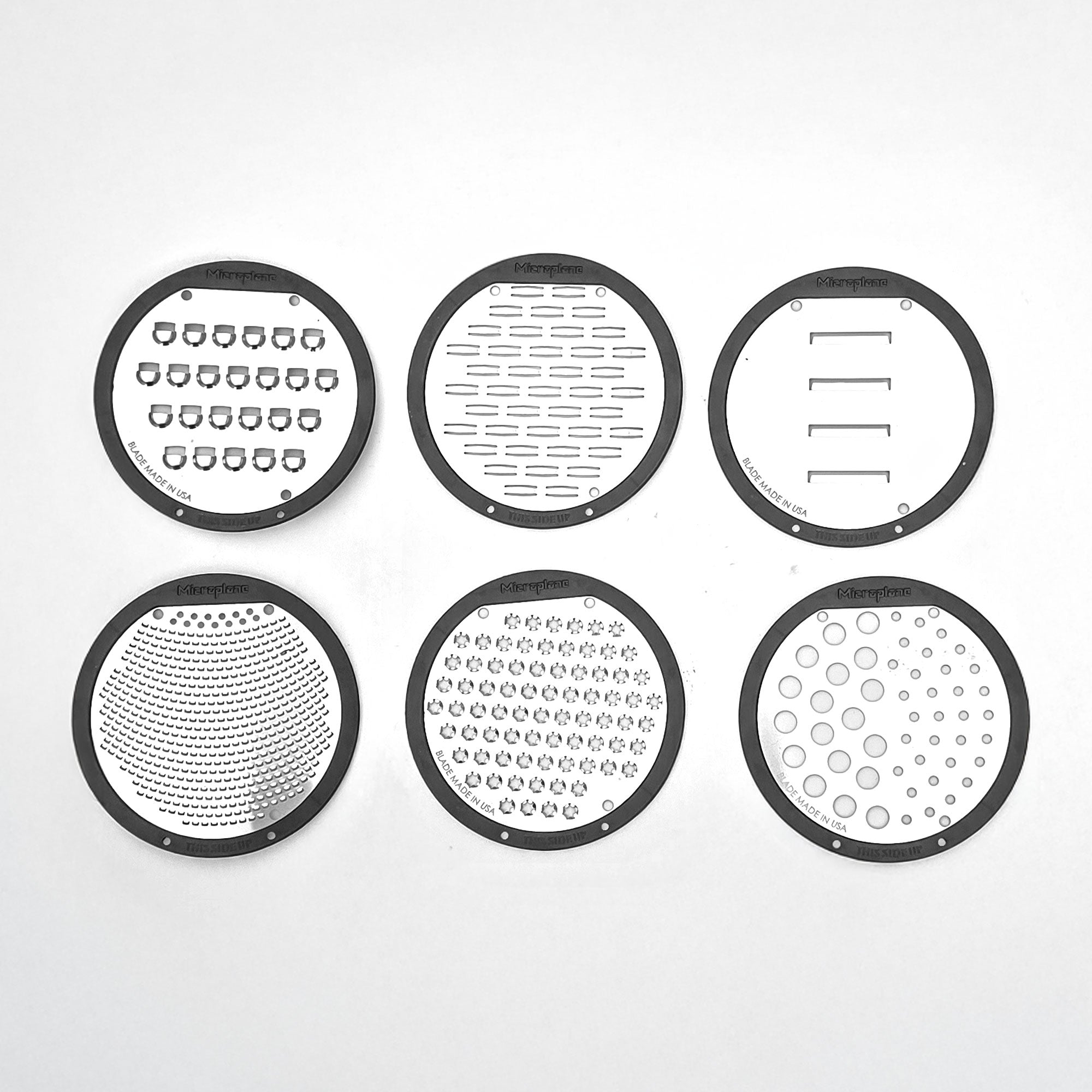 Set of six circular metalgraters with different patterns on a white background