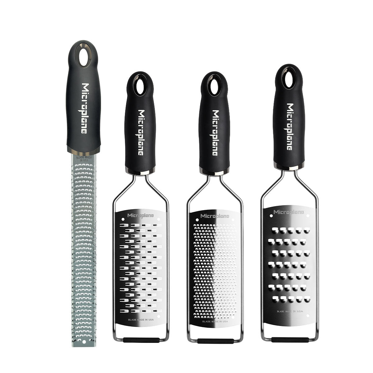 Set of four Microplane graters on a white background