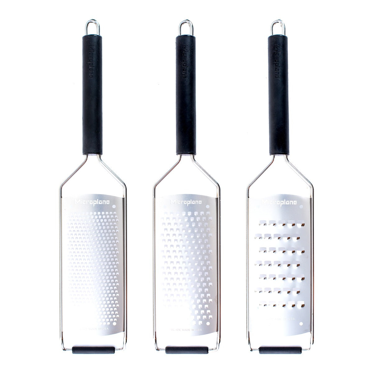 Three kitchen graters in a row, each with a black handle and a silver metal body showing different grating mesh densities, on a plain white background.